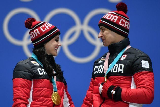 Canada's gold medallists Tessa Virtue and Scott Moir pose on the podium during the medal ceremony for the figure skating ice dance on February 20, 2018.