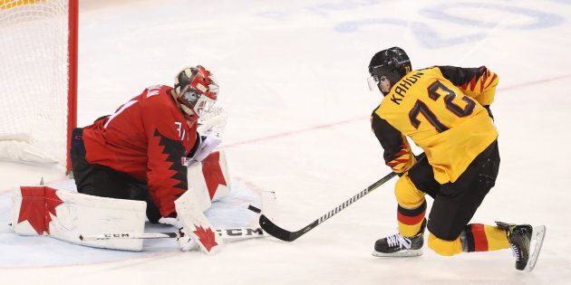 Kevin Poulin of Canada stops a penalty shot by Dominik Kahun of Germany during the Men's Play-offs Semifinals at the PyeongChang Winter Olympic Games on Friday in Gangneung, South Korea.