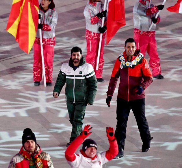 Pakistan's Muhammad Karim (L) and Tonga's Pita Taufatofua are photographed during the closing ceremony of the Pyeongchang 2018 Olympic Games in Pyeongchang county, South Korea, on Feb. 25, 2018.