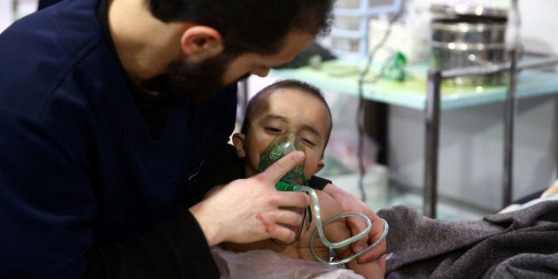 A man and a child are seen in a hospital in the besieged town of Douma, Eastern Ghouta, Damascus, Syria on Feb. 25, 2018.