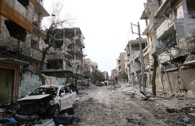 Damaged cars and buildings are seen in the besieged town of Douma, Eastern Ghouta, Damascus, Syria on Feb. 25, 2018.