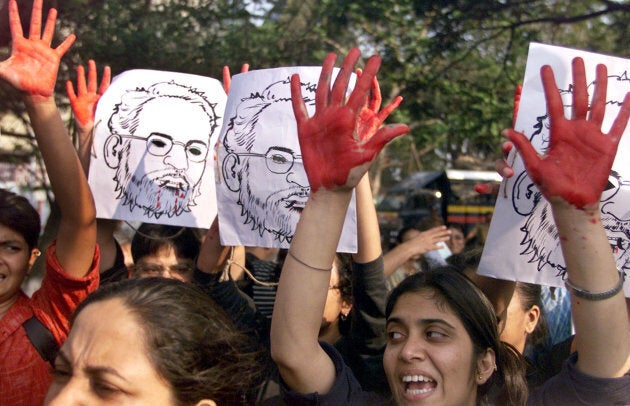 Activists raise their hands covered in red paint during a demonstration against the visit of then Chief Minister of Gujarat, Narendra Modi in Bombay on Jan. 12, 2003