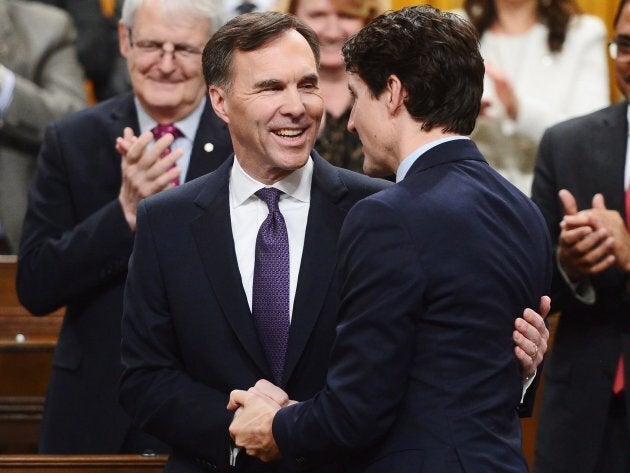 Finance Minister Bill Morneau is congratulated by Prime Minister Justin Trudeau after delivering the federal budget in the House of Commons in Ottawa on Feb. 27, 2018.