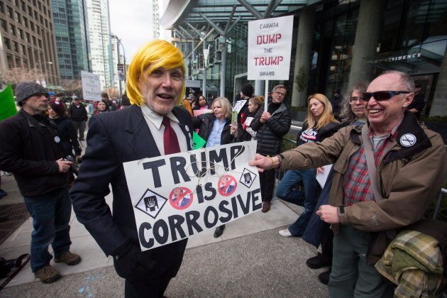 A man dressed as U.S. President Donald Trump jokes with protesters outside the official opening of the Trump International Hotel and Tower in Vancouver, B.C., on Tuesday February 28, 2017.