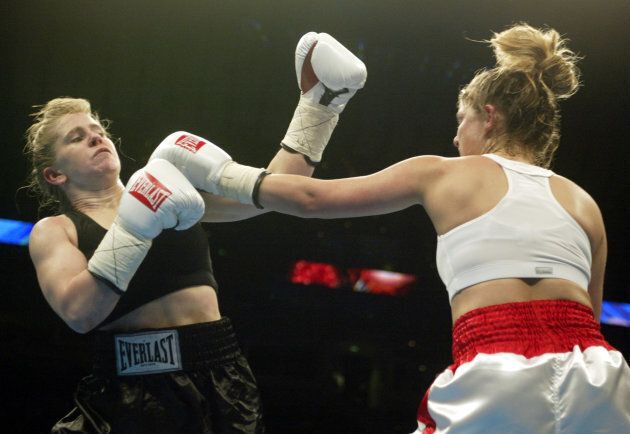 Tonya Harding (L) and Samantha Browning fight during their bout at the Pyramid in Memphis, Feb. 22, 2003. Browning defeated Harding in a split decision after four rounds.