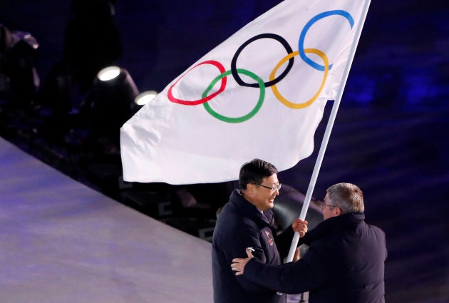 Pyeongchang Mayor Shim Jae-kook hands over the Olympic flag to IOC President Thomas Bach during the closing ceremony of the 2018 Winter Olympic Games.