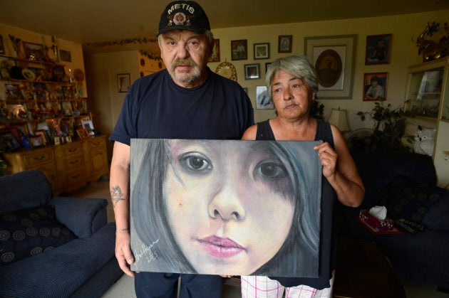 Joe and Thelma Favel hold a framed collage tribute to their niece, Tina Fontaine, who was murdered.