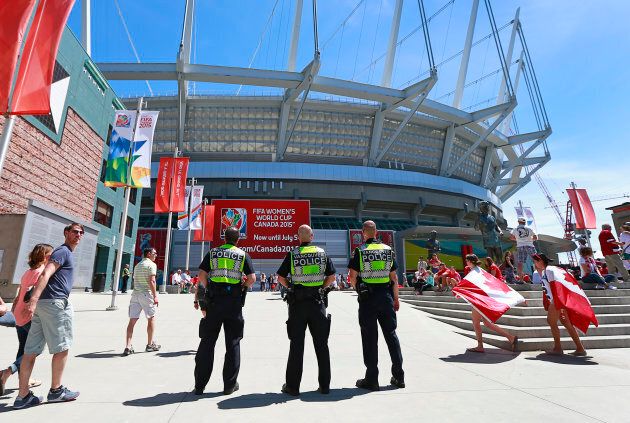 Vancouver police officers stand outside B.C. Place stadium before the FIFA Women's World Cup Canada 2015 Round 16 match between Switzerland and Canada June 21, 2015.