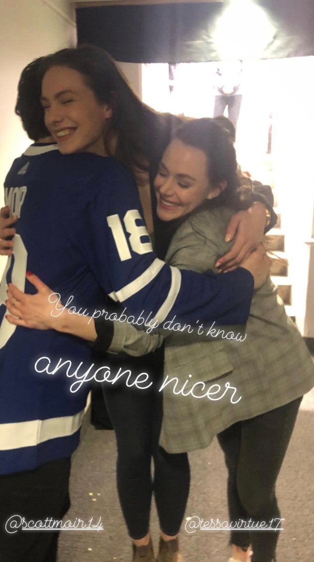 Penny Oleksiak hugs Tessa Virtue and Scott Moir at a Toronto Maple Leafs game on Saturday.