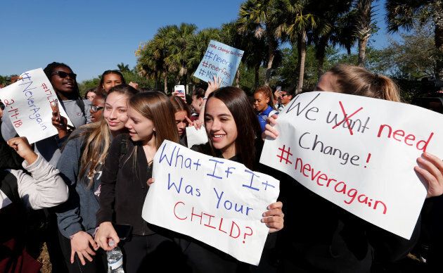 SStudents carry signs as they march from Westglades Middle School to a nearby park with students from Marjory Stoneman Douglas High School as part of a National School Walkout to honour the 17 students and staff members killed at the school in Parkland, Florida, on March 14, 2018.