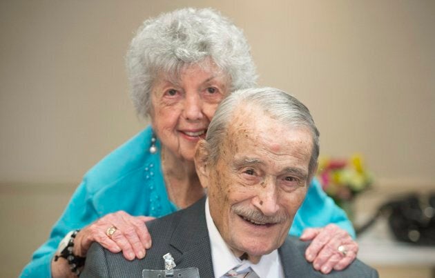 100 year old Edward Sohmer gets a hug from a friend during an event to celebrate twenty centenarians who live at the Waldorf Residence in Montreal, March 11, 2018.