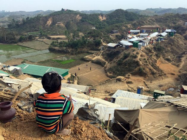 A boy sits on a a hillside in the Chakmakul camp for Rohingya refugees in southern Bangladesh, Feb. 8, 2018.