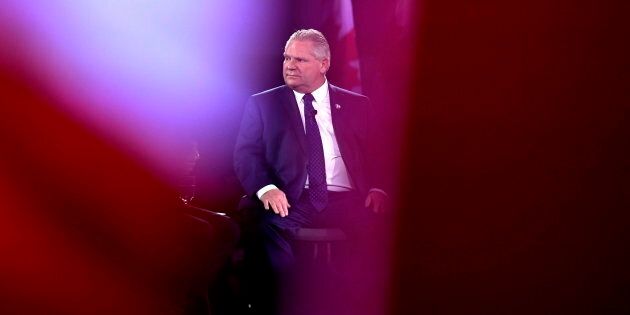 Before being elected Ontario PC Party leader, candidate Doug Ford is seen past Canadian flags as he participates in a question-and-answer session at the Manning Networking Conference in Ottawa on Feb. 10, 2018.