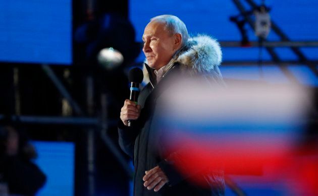 Russian President Vladimir Putin delivers a speech during a rally and concert marking the fourth anniversary of Russia's annexation of the Crimea region, at Manezhnaya Square in central Moscow on March 18, 2018.