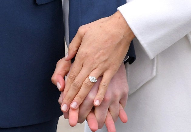 Prince Harry and Meghan Markle hold hands at an official photocall to announce their engagement in November.