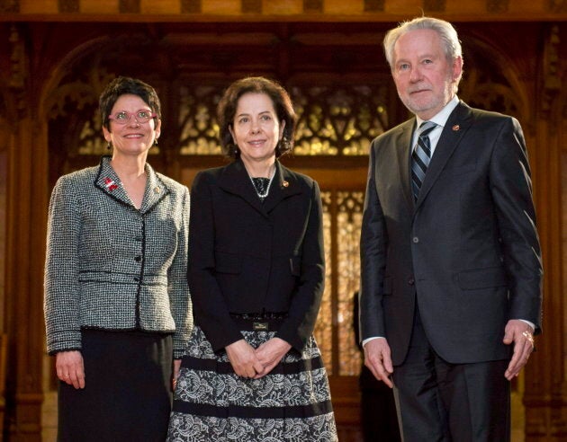 Raymonde Saint-Germain (centre) stands with Senators Raymonde Gagne (left) and Peter Harder before being sworn into the Senate, on Parliament Hill on Dec. 1, 2016 in Ottawa.