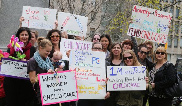 Mothers and their children, along with child care advocates, protested in front of the Legislature buildings at Queens Park on May 9, 2014, in Toronto.