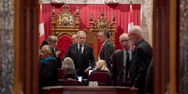 Sen. Peter Harder, government representative in the Senate, left, speaks with Sen. Larry Smith, leader of the opposition in the Senate, before a vote on Bill C-45, the Cannabis Act, in the Senate chamber on Parliament Hill in Ottawa on Thursday.