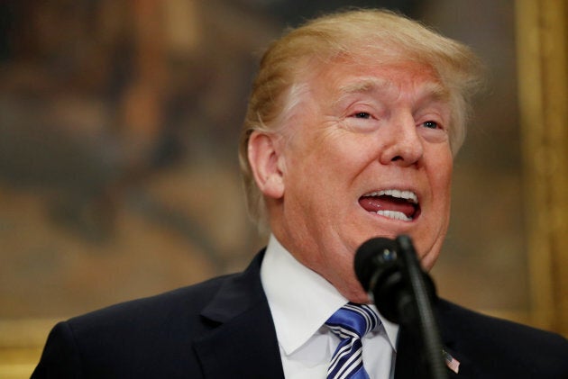 U.S. President Donald Trump announces a presidential proclamation placing tariffs on steel and aluminum imports while surrounded by workers from the steel and aluminum industries at the White House in Washington, D.C., on March 8, 2018.