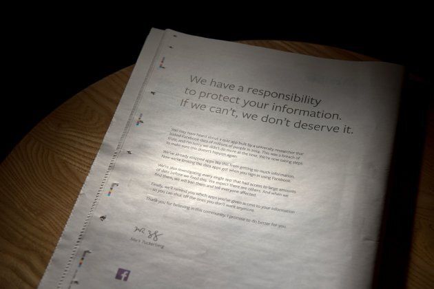 A newspaper featuring a full-page advertisment, taken out by Mark Zuckerberg, the chairman and chief executive officer of Facebook to apologise for the large-scale leak of personal data from the social network, lies on a table in Ripon, England on March 25, 2018.