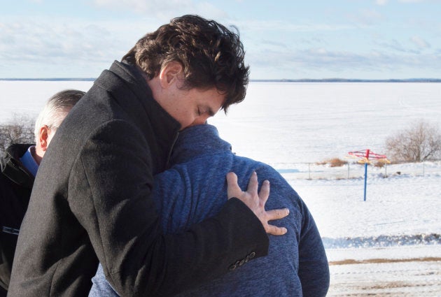 Prime Minister Justin Trudeau hugs a resident in La Loche, Sask. on Jan. 29, 2016. Trudeau travelled to the site of Canada's worst mass shooting in a decade.