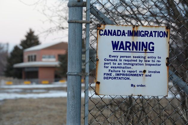 A sign is seen on a fence on the U.S. side of the former Canada-U.S. border crossing in Noyes, Minnesota, March 28, 2017.