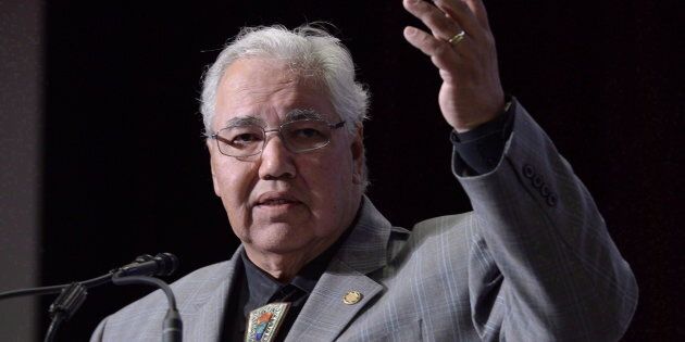 Commission chairman Justice Murray Sinclair raises his arm asking residential school survivors to stand at the Truth and Reconciliation Commission in Ottawa on June 2, 2015.