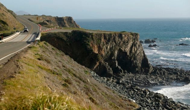 A truck drives by the pullout where the SUV of Jennifer and Sarah Hart was recovered off the Pacific Coast Highway, near Westport, Calif. on March 28, 2018.