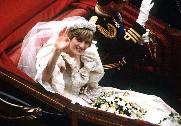 The Prince and Princess of Wales return to Buckingham Palace by carriage after their wedding, 29th July 1981. She wears a wedding dress by David and Elizabeth Emmanuel and the Spencer family tiara.