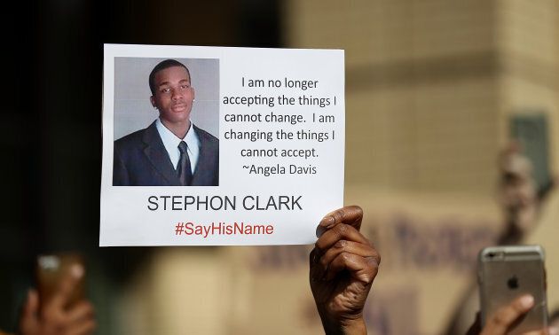 A protester holds a photo of Stephon Clark during a Black Lives Matter demonstration outside of Sacramento City Hall on March 22, 2018 in Sacramento, Calif.