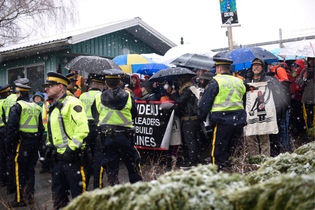 Demonstrators gather outside Kinder Morgan's Burnaby Mountain facility in B.C. Hundreds have been arrested for violating a court injunction ordering protesters to stay at least five metres away from Kinder Morgan's gates.