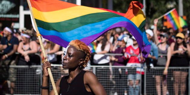 A woman holds a flag during the Pride parade in Toronto on June 25, 2017.
