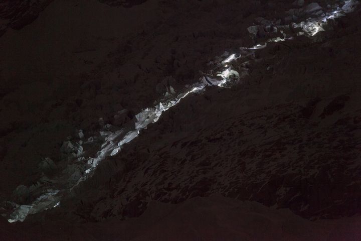 Climbers making their way through the Khumbu Icefall at night.