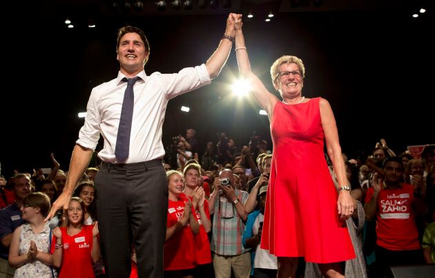 Ontario Premier Kathleen Wynne and then-Liberal Party leader Justin Trudeau join hands during an election rally in Toronto.