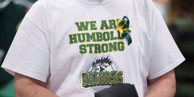 A man wears a Humboldt Broncos shirt during a vigil at the Elgar Petersen Arena, home of the Humboldt Broncos, to honour the victims of a fatal bus accident in Humboldt, Sask. on April 8, 2018.