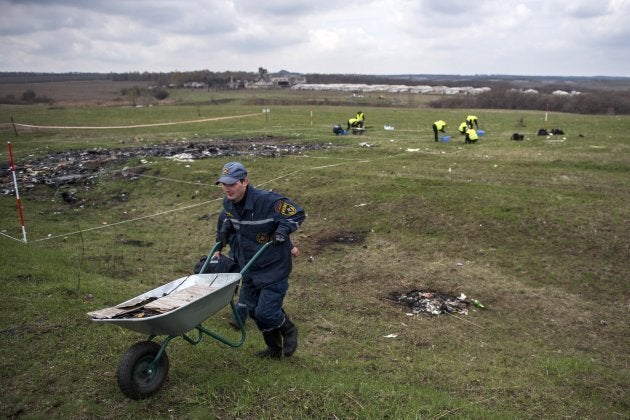 Dutch and Malaysian investigators and local authorities work on April 16, 2015 at the MH17 plane crash site near the village of Grabove in the self-proclaimed Donetsk People's Republic. The plane was shot down over war-torn eastern Ukraine.