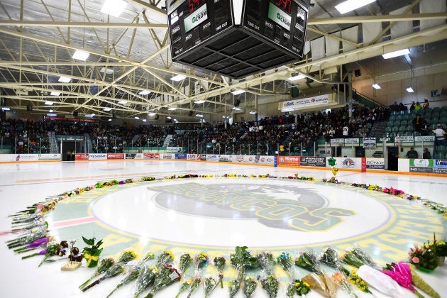 Flowers lie on the ice as people gather for a vigil at the Elgar Petersen Arena, home of the Humboldt Broncos on April 8, 2018.