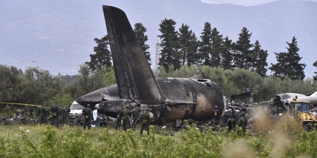 Rescuers are seen around the wreckage of an Algerian army plane which crashed near the Boufarik airbase, from where the plane had taken off, on April 11, 2018.