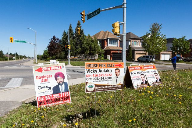 Open house signs displayed on the side of a road in Brampton, Ont., Sat. May 20, 2017. The slowdown in the housing market is one factor creating uncertainty in Canada's economy.