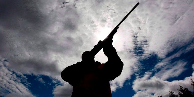 A rifle owner checks the sight of his rifle at a hunting camp property in rural Ontario, west of Ottawa, on Sept. 15, 2010.