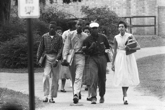 Nine students attending integrated classes at Little Rock's Central High School are shown as they left the school to walk to a waiting Army station wagon which takes them to and from school.