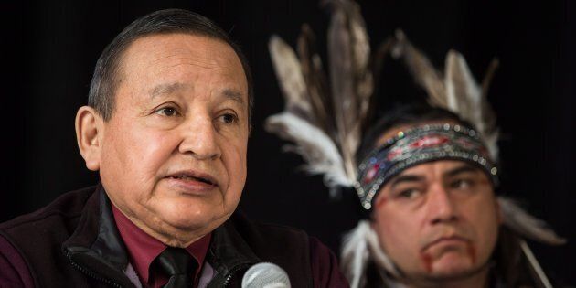 Grand Chief Stewart Phillip, left, president of the Union of B.C. Indian Chiefs, speaks as Will George, a member of the Tsleil-Waututh First Nation and a guardian at the watch house near Kinder Morgan's Burnaby facility, listens during a news conference in Vancouver on April 16, 2018.