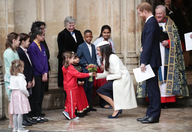 Meghan Markle and Prince Harry talking to children as they leave the Commonwealth Service at Westminster Abbey, London.
