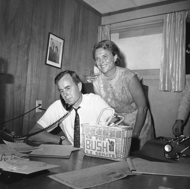 In this 1964 file photo, George Bush, candidate for the Republican nomination for the U.S. Senate, gets returns by phone at his headquarters in Houston as his wife Barbara looks on. The former first lady and mother to former president George W. Bush passed away on Tuesday.