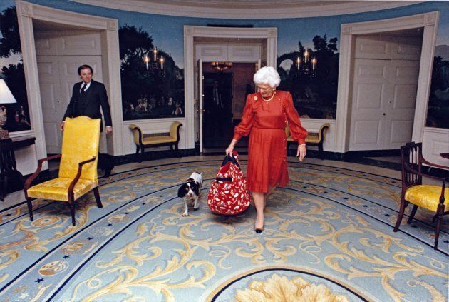 First lady Barbara Bush walks through the Diplomatic Reception Room of the White House with her dog, Millie, in Washington, D.C. on March 24, 1989.