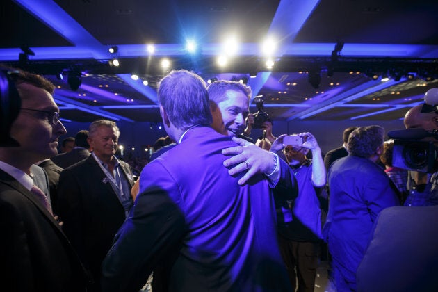 Andrew Scheer, leader of Canada's Conservative Party, center right, hugs Maxime Bernier, Member of Parliament (MP) and Conservative Party leader candidate, centre left, after Scheer is named the party's next leader on May 27, 2017.