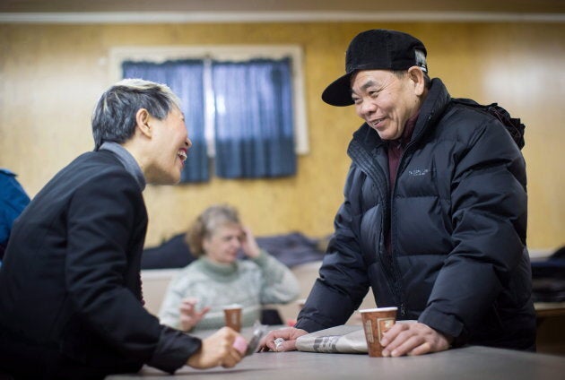 Amie Peacock, left, founder of the volunteer group Beyond the Conversation, speaks with Simon Law during a weekly group meeting to help people practice their English skills, combat social isolation and foster relationships, in Vancouver on Feb. 23, 2018.