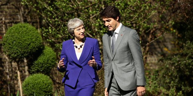 Britain's Prime Minister Theresa May speaks with Prime Minister Justin Trudeau in the gardens of 10 Downing Street in London on April 18, 2018.
