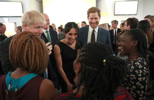 Meghan Markle and Prince Harry speak with guests as they attend the Women's Empowerment reception.