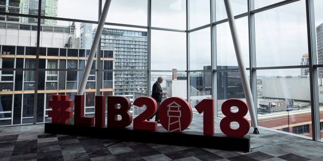A man walks past a sign at the federal Liberal national convention in Halifax on April 20, 2018.
